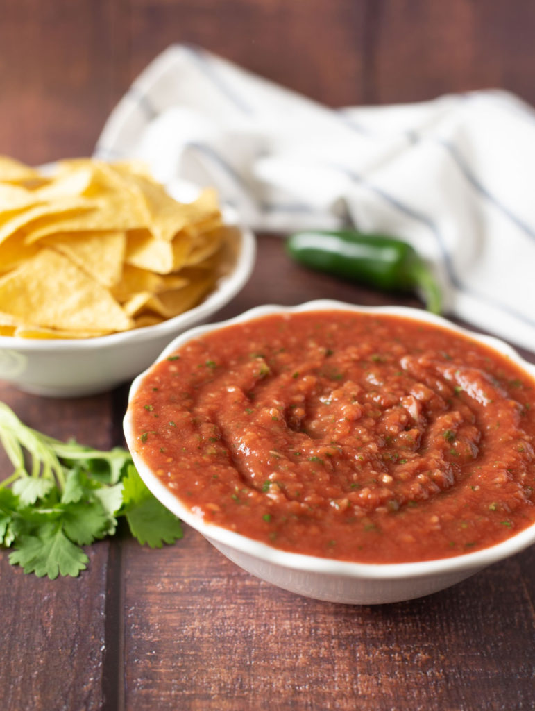 salsa in a bowl with tortilla chip 